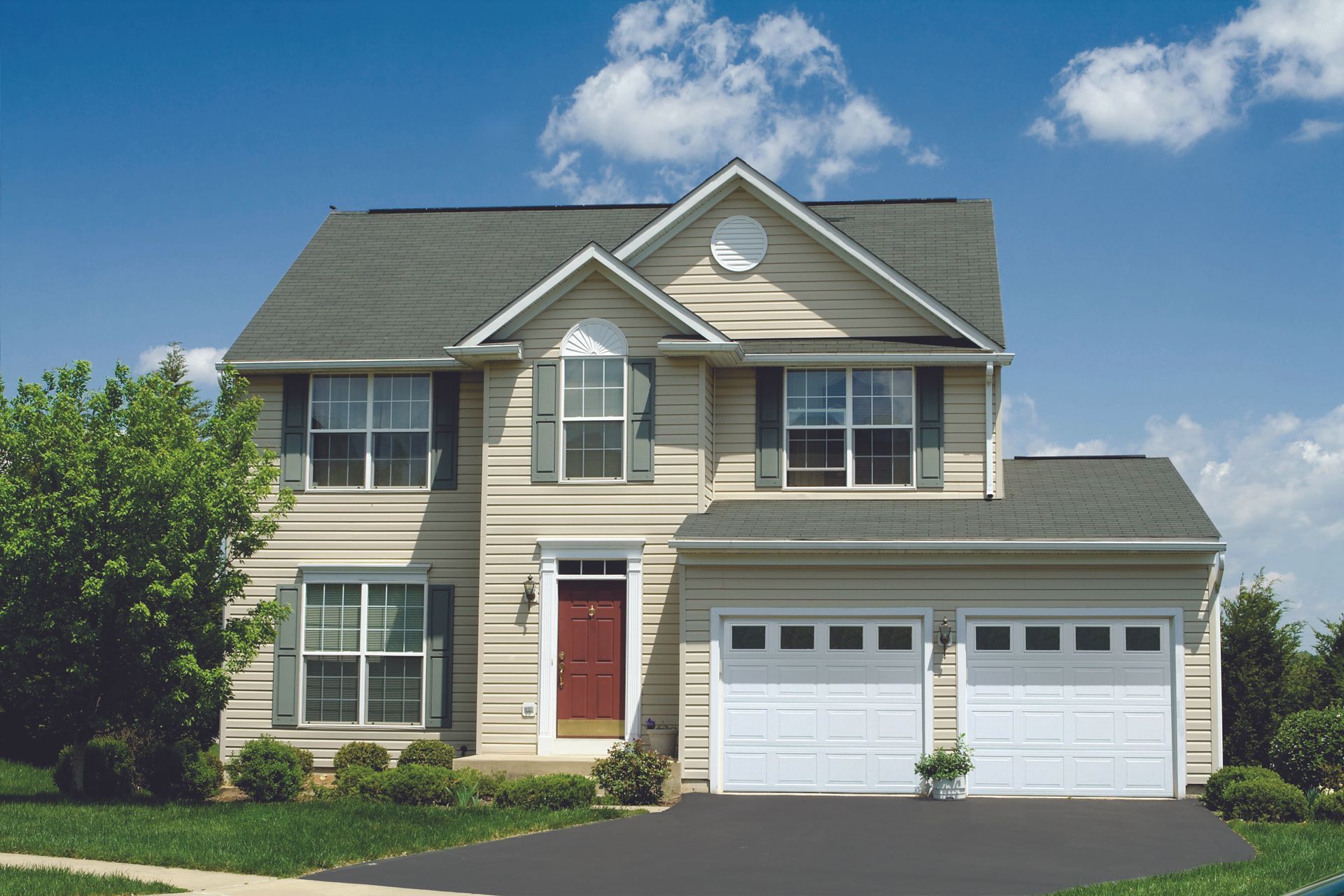 A white garage door is sitting next to a body of water.