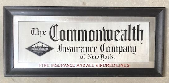 Framed black-and-white sign for The Commonwealth Insurance Company of New York, with red “Fire Insurance” text