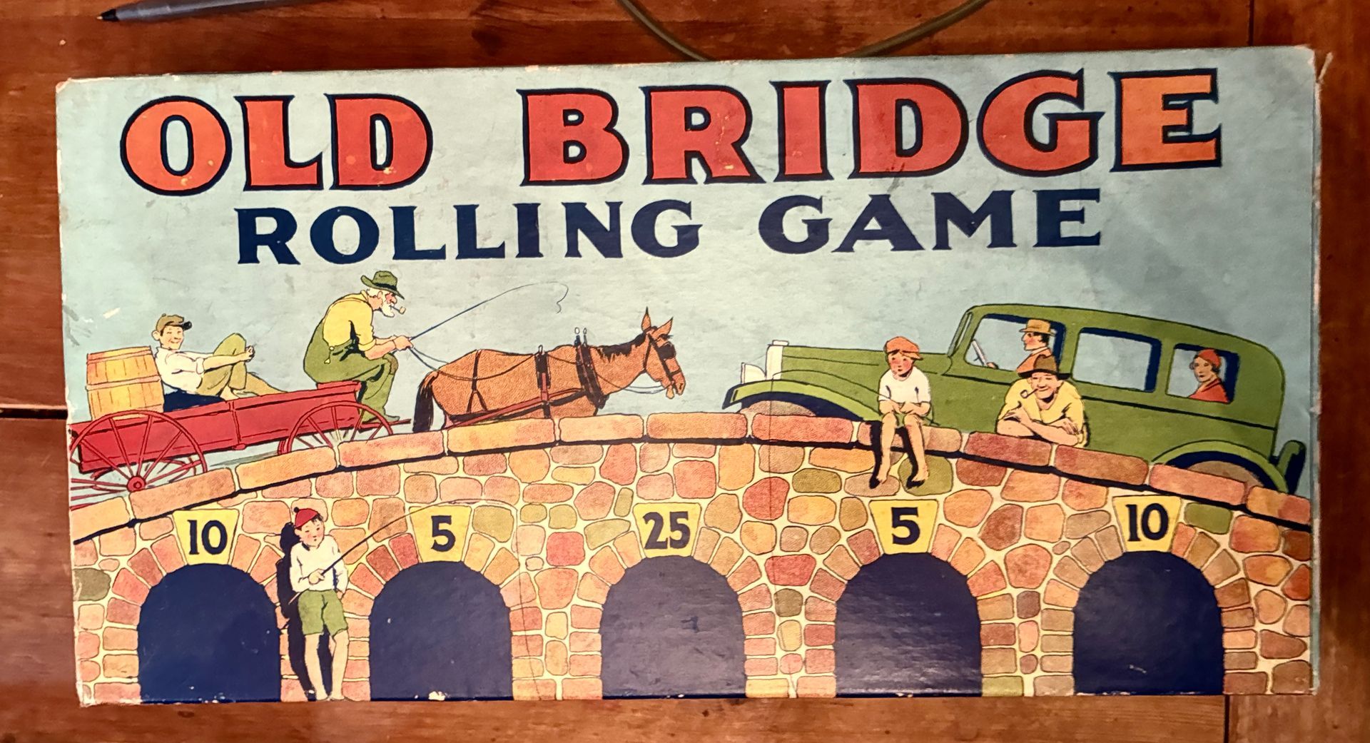 Old Bridge Rolling Game sign with a horse-drawn wagon crossing a brick bridge above numbered arches