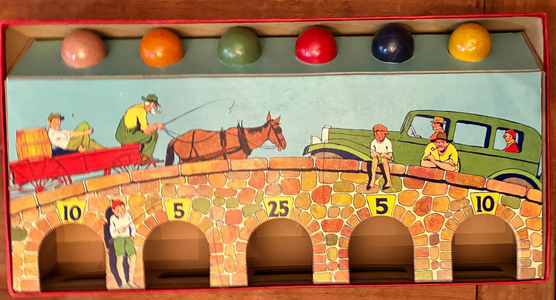 Old Bridge Rolling Game sign with a horse-drawn wagon crossing a brick bridge above numbered arches