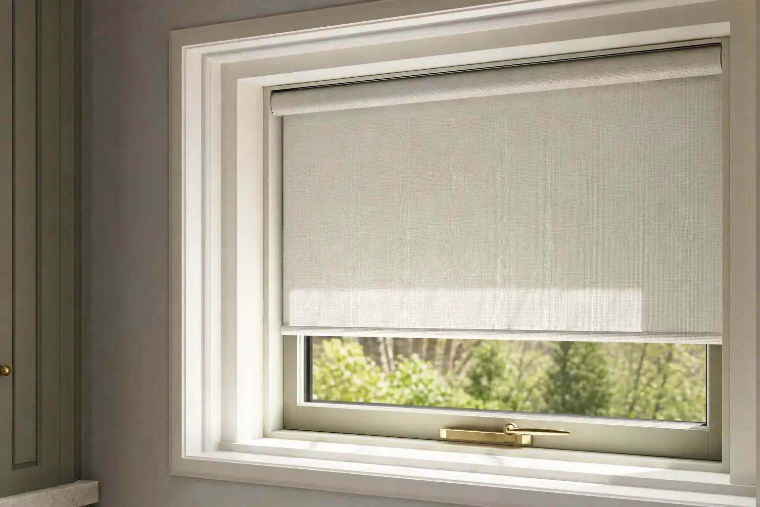 Closed white roller blind over a window with a brass latch, showing greenery outside Closed white roller blind over a window with a brass latch, showing greenery outside