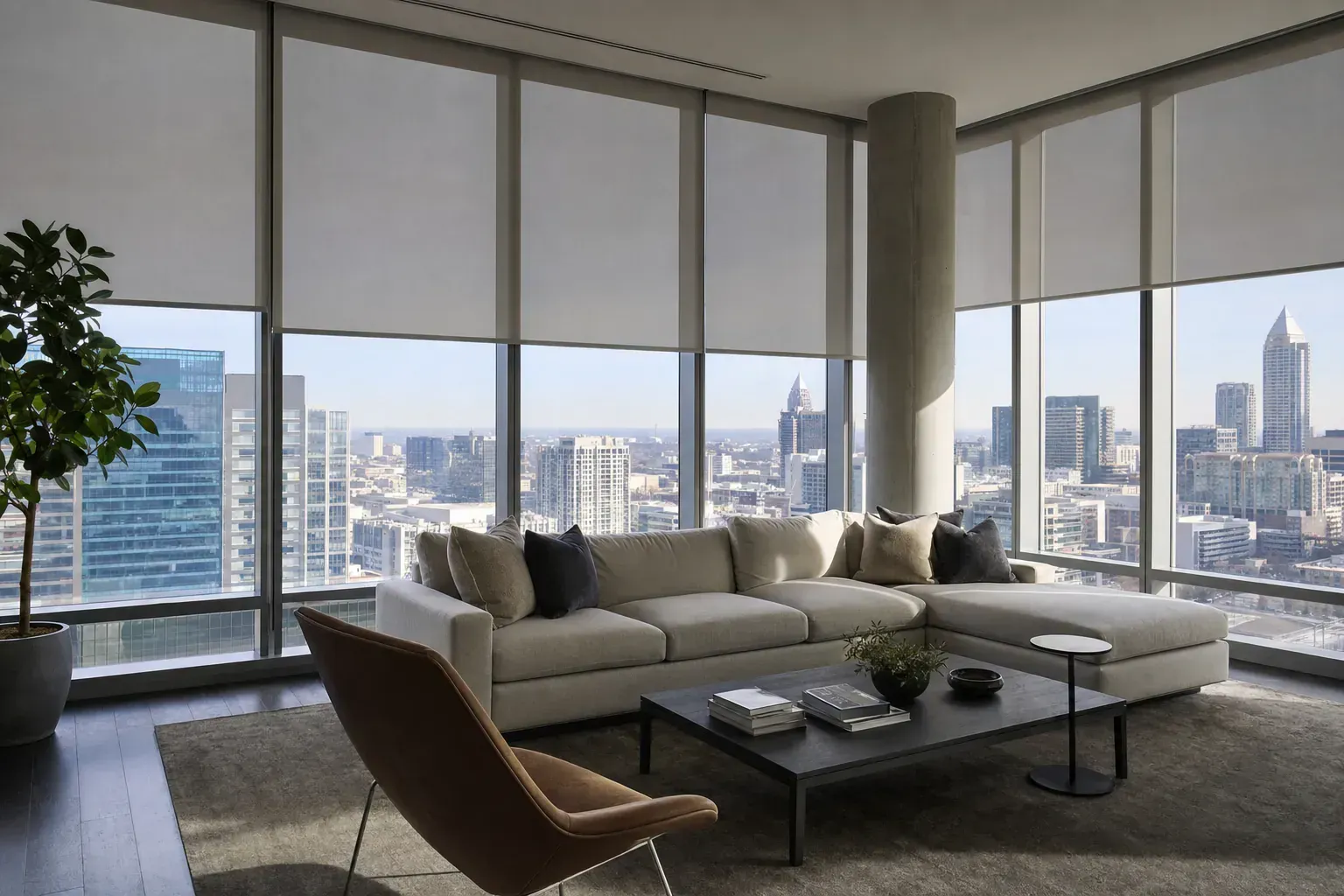 Modern living room with large windows, sectional sofa, and city skyline view