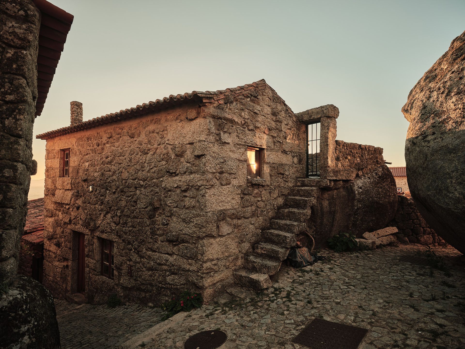 A stone building with stairs leading up to it