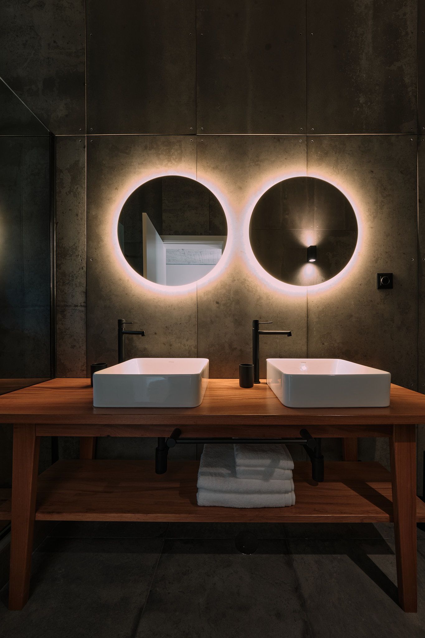 A bathroom with two sinks and two mirrors.
