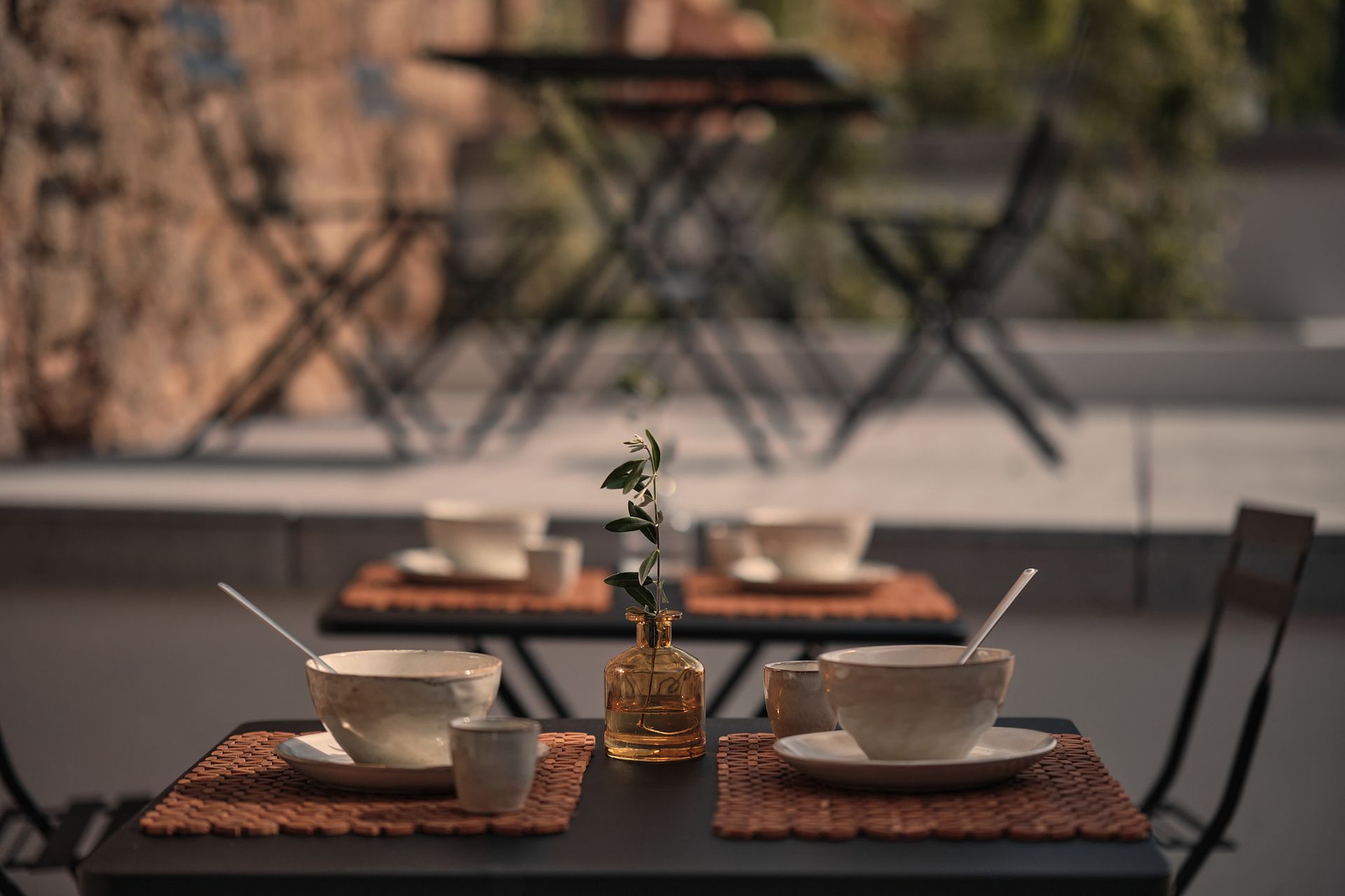 A couple of tables with cups and saucers on them.