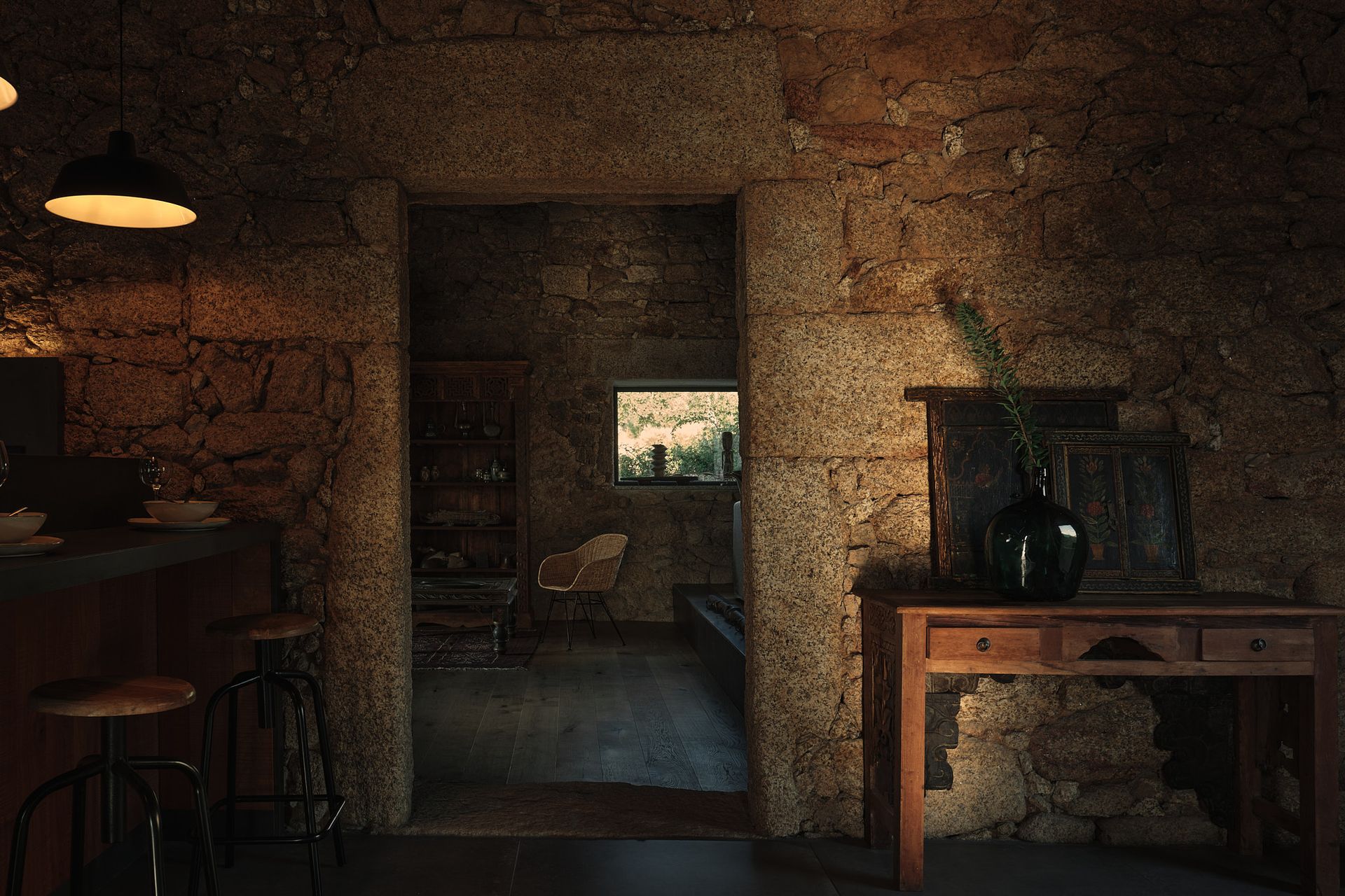 A room with a stone wall and a wooden table