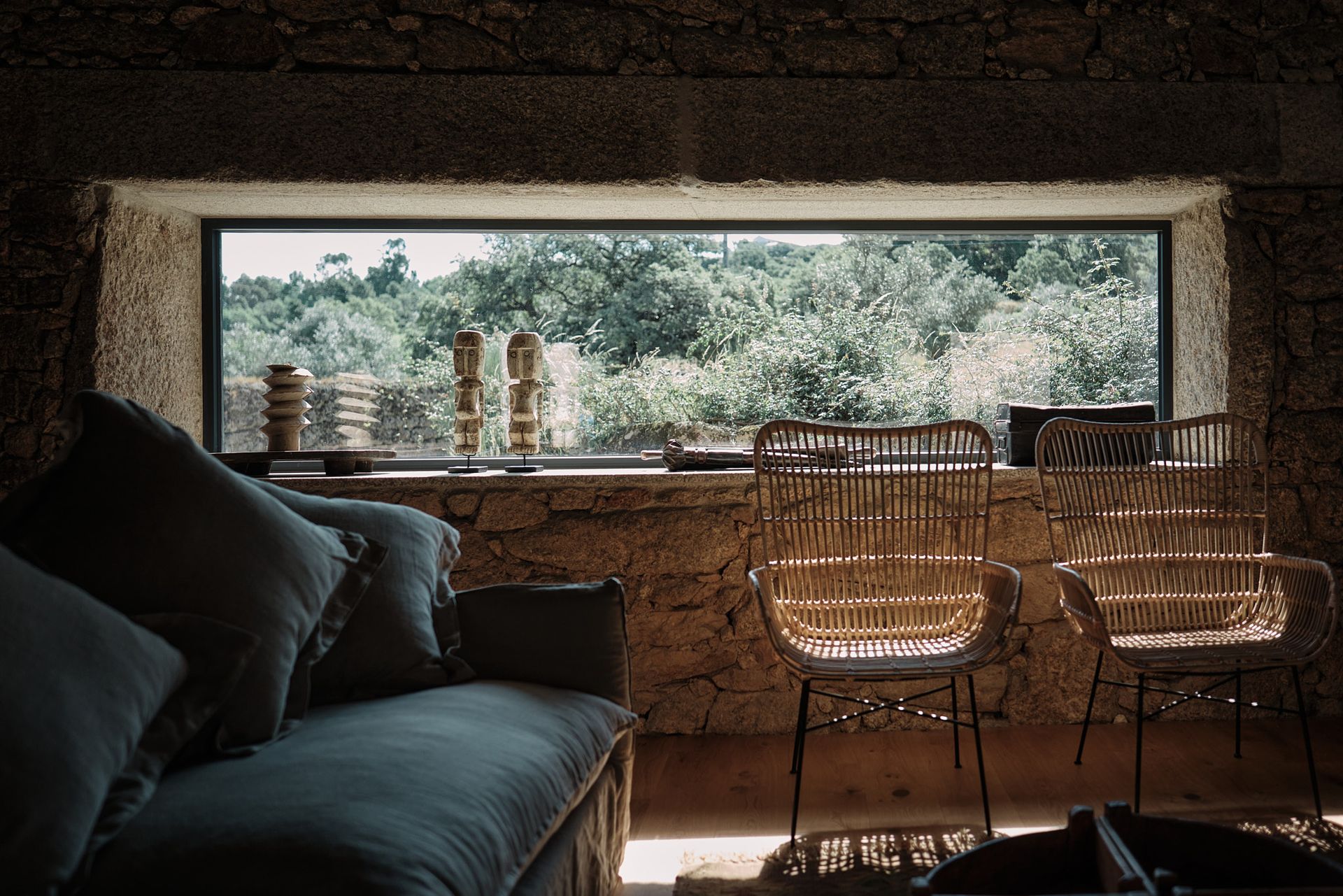 A living room with a couch , chairs and a large window.