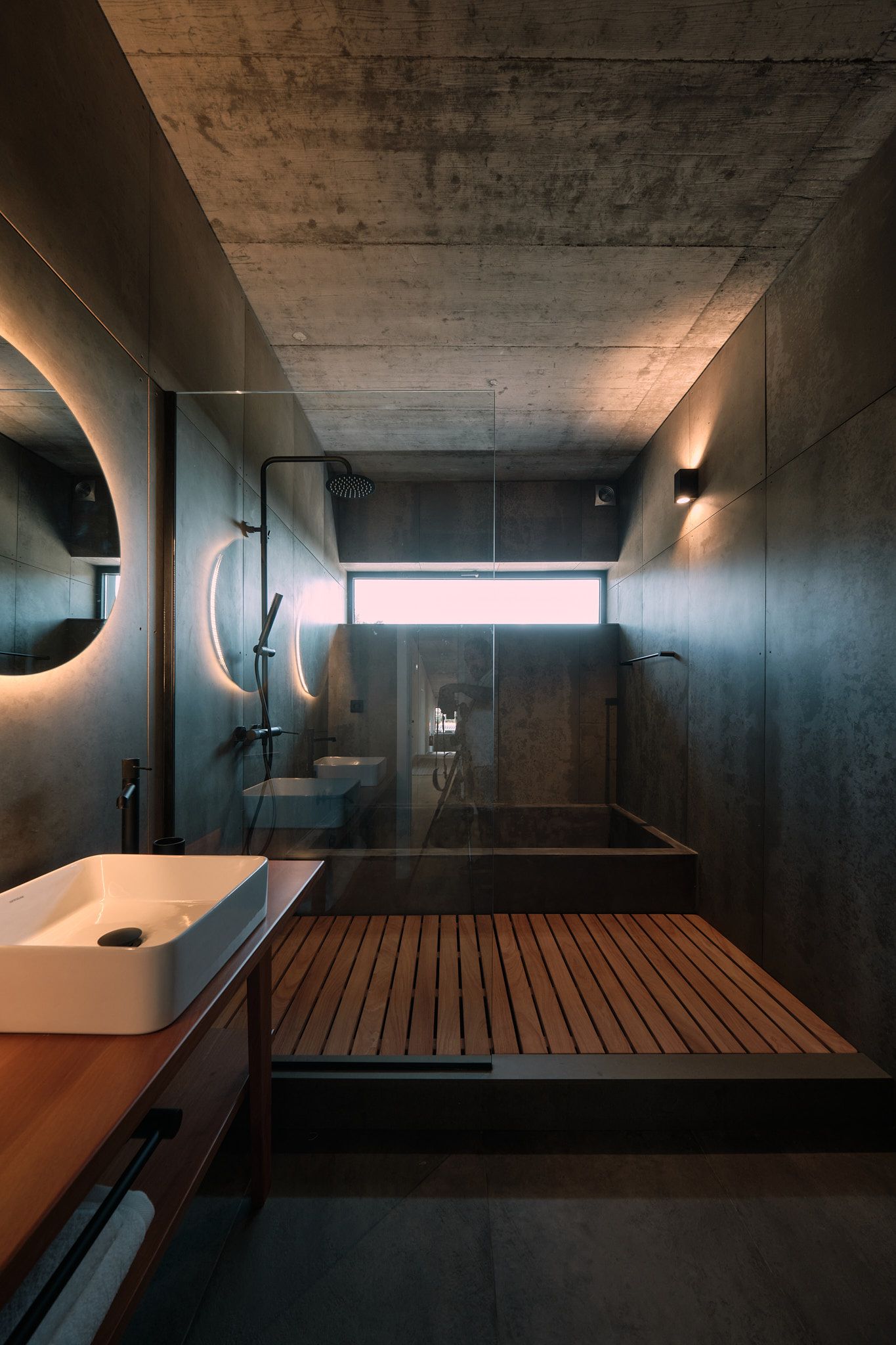 A bathroom with a sink , mirror and bathtub.