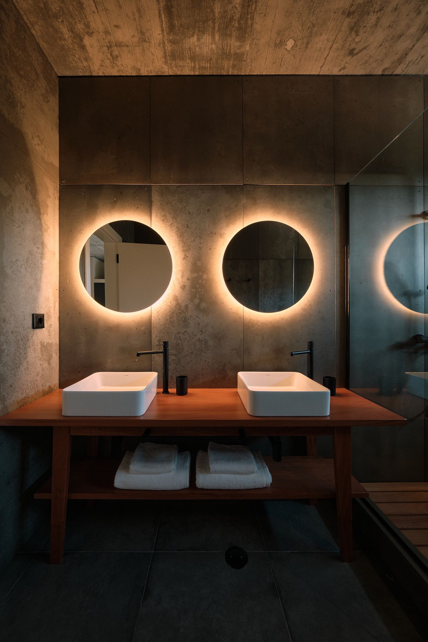 A bathroom with two sinks and two mirrors.