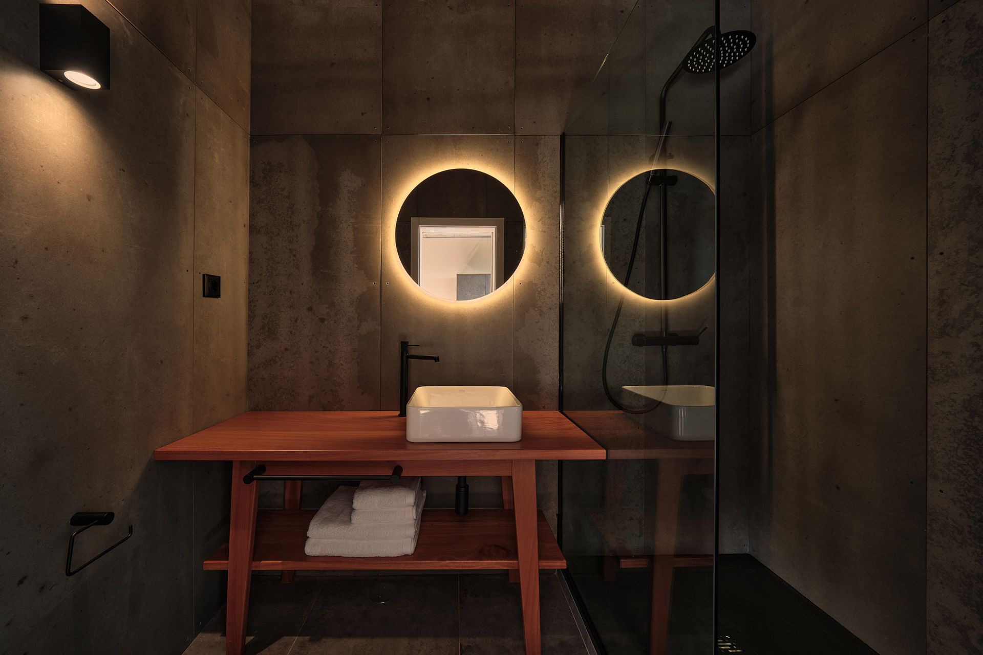 A bathroom with a sink , mirror and shower.