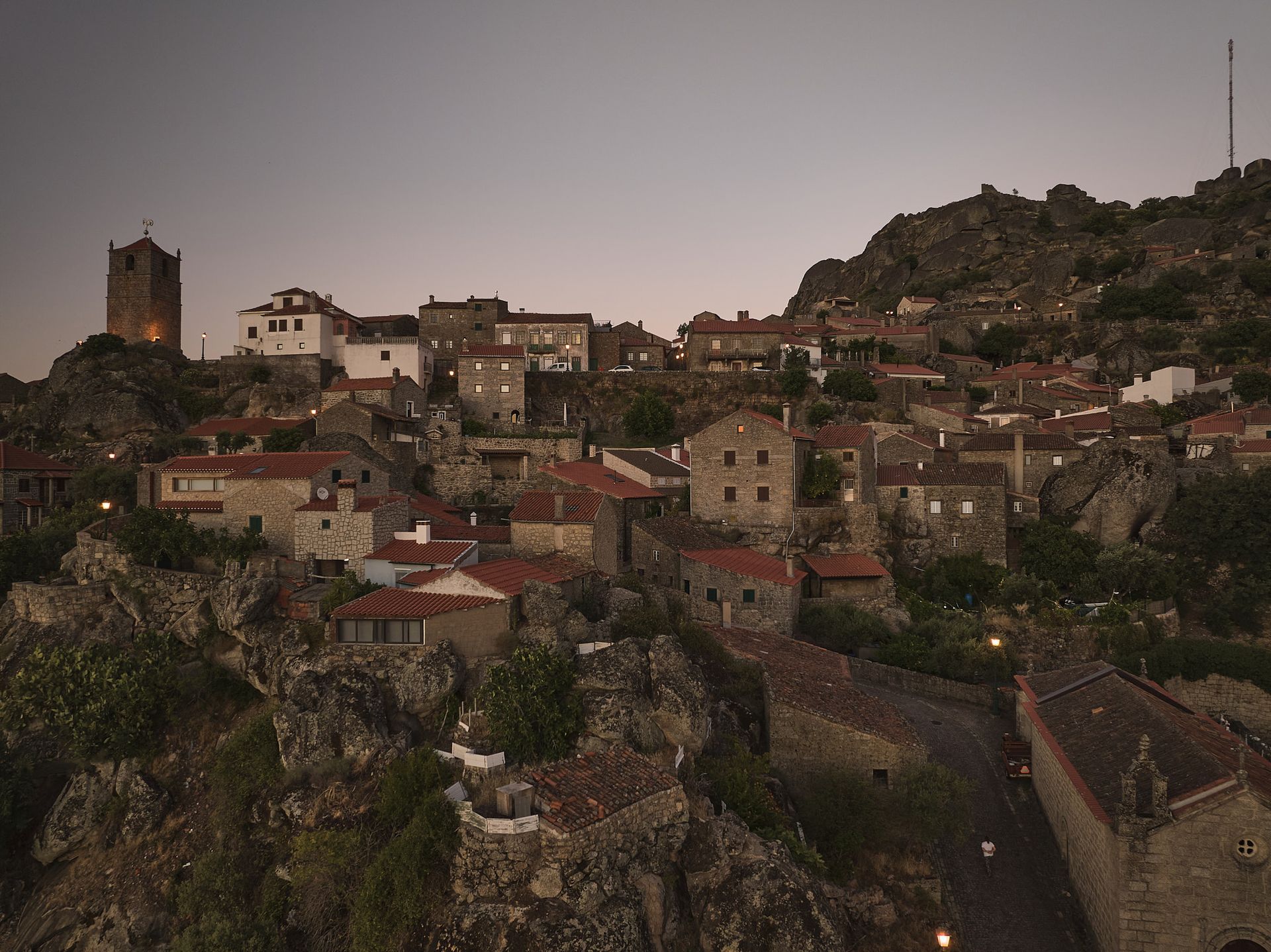 An aerial view of a small town on top of a hill