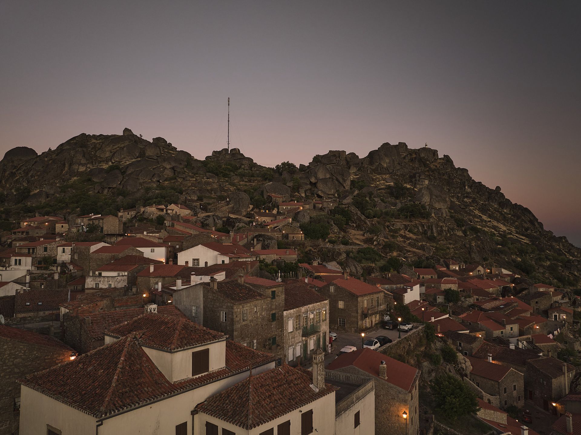 An aerial view of a small town with a mountain in the background