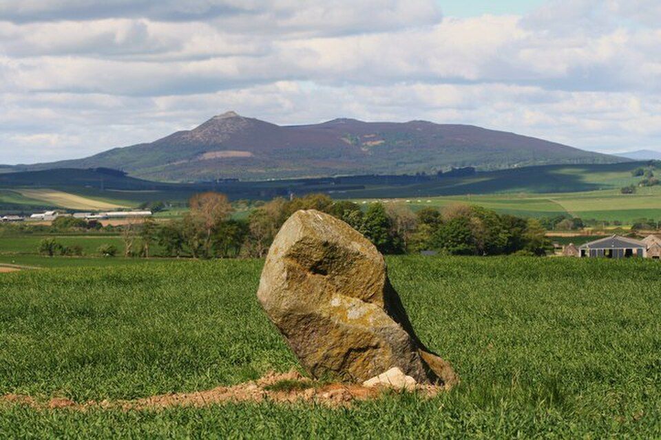 Mountains in the background and an ancient stone in the foregroud