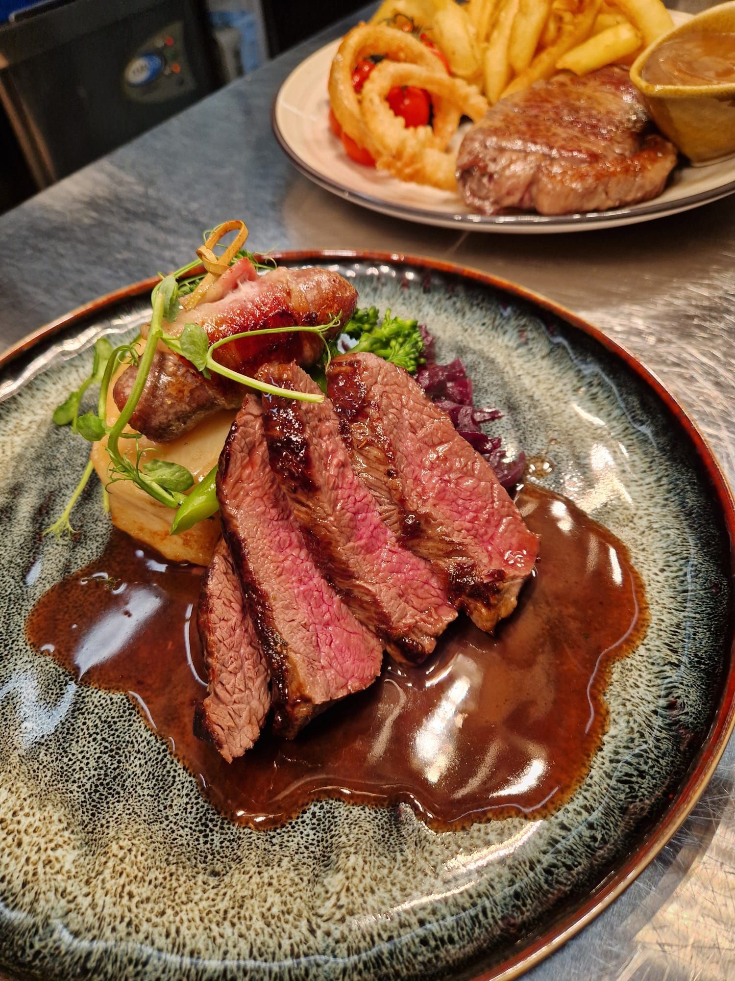 A plate with four slices of Tullynessle venison with red cabbage and surrounded by cassis sauce