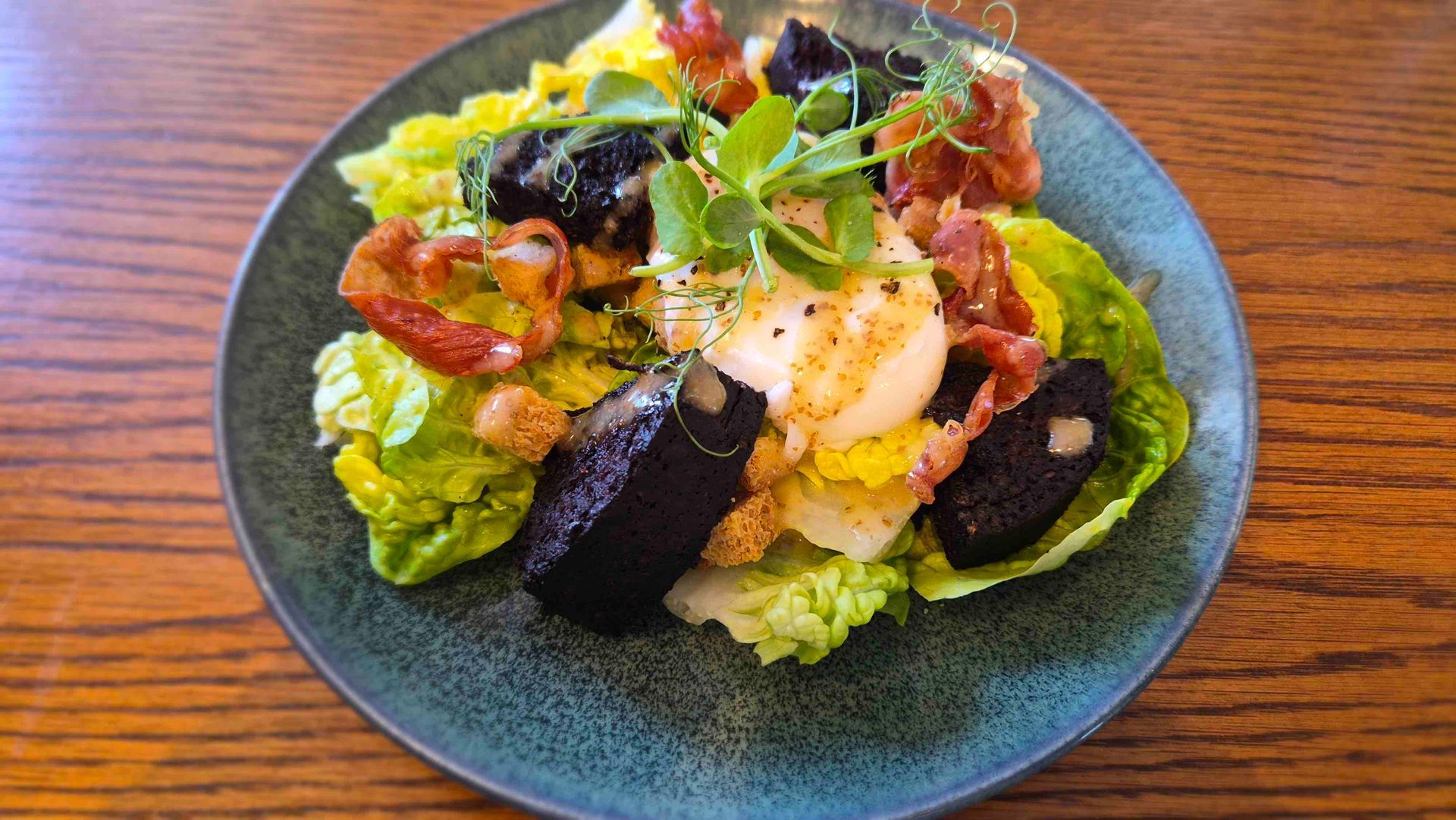 Stornoway Black Pudding with Crispy Prosciutto, Poached Egg and Salad