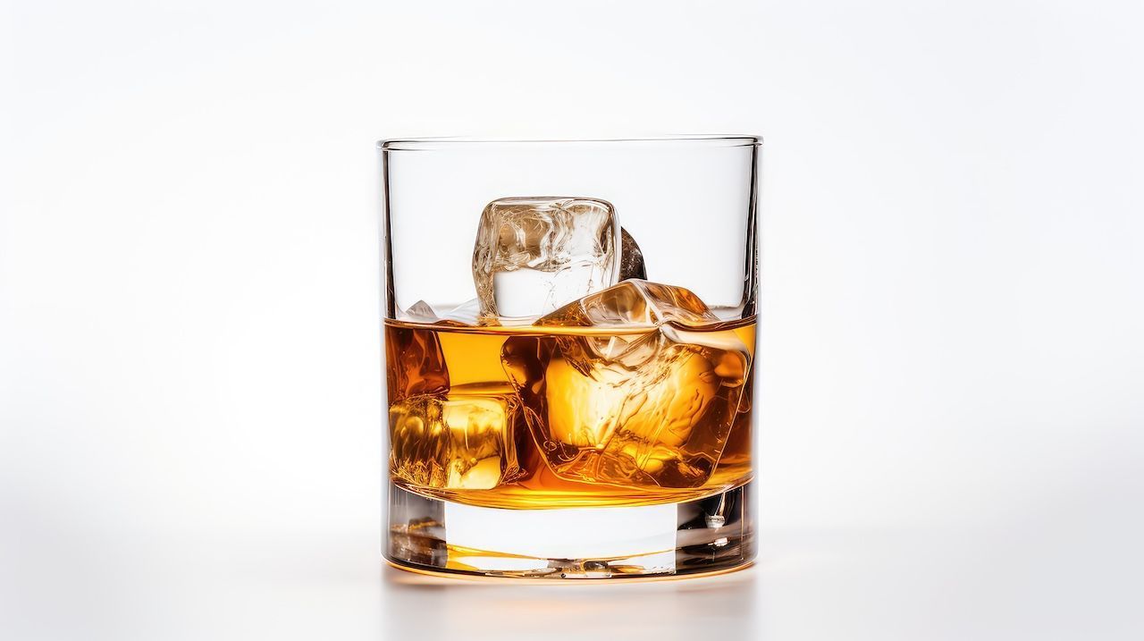 A glass of whisky with ice cubes known as Whisky on the Rocks