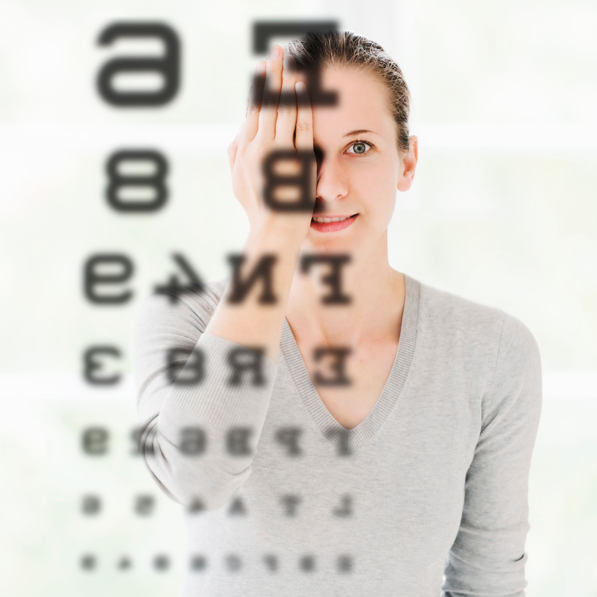 A woman is looking at a chart of letters and numbers