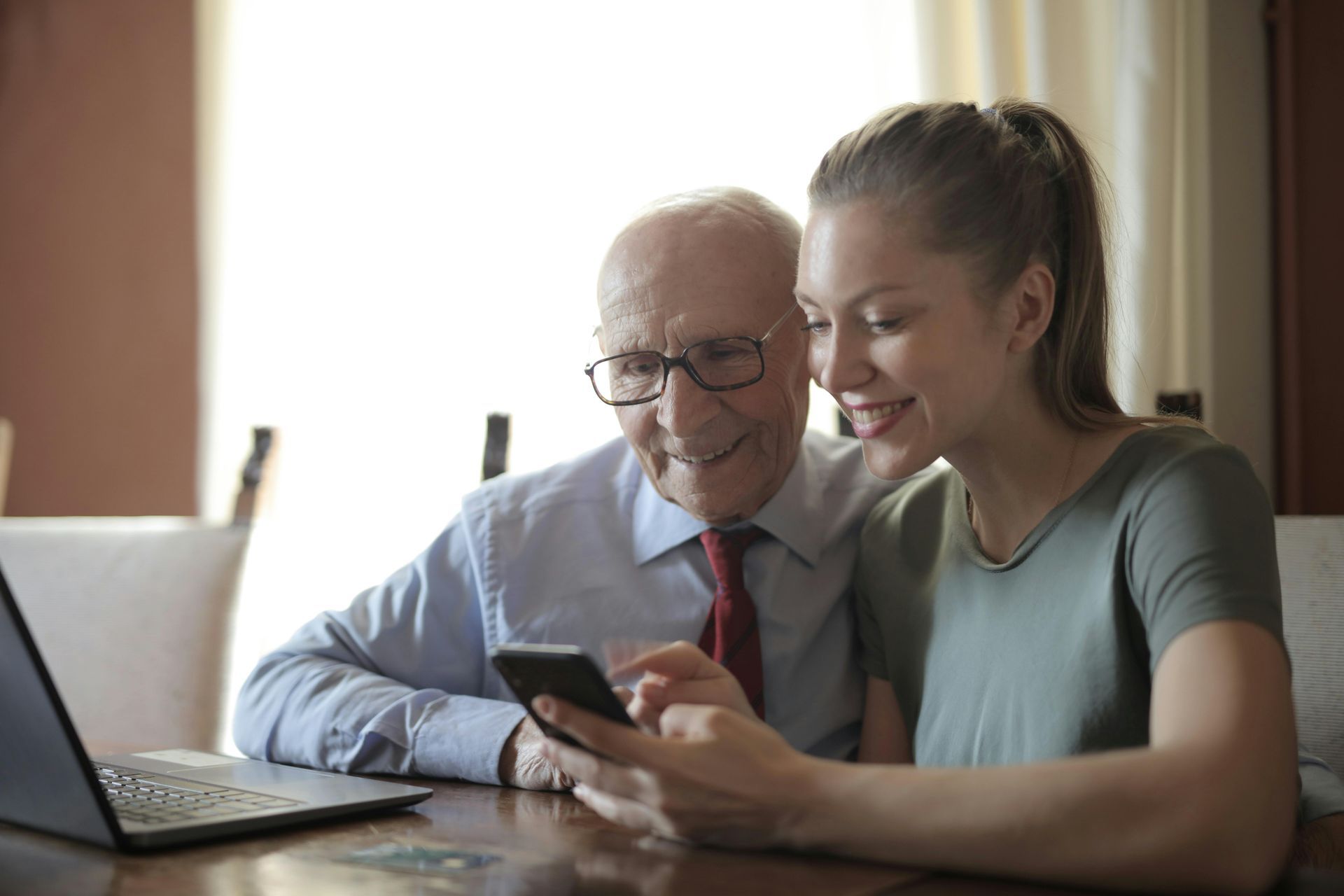 Estate planning advisor talking clients through Will and LPA paperwork during a home visit.
