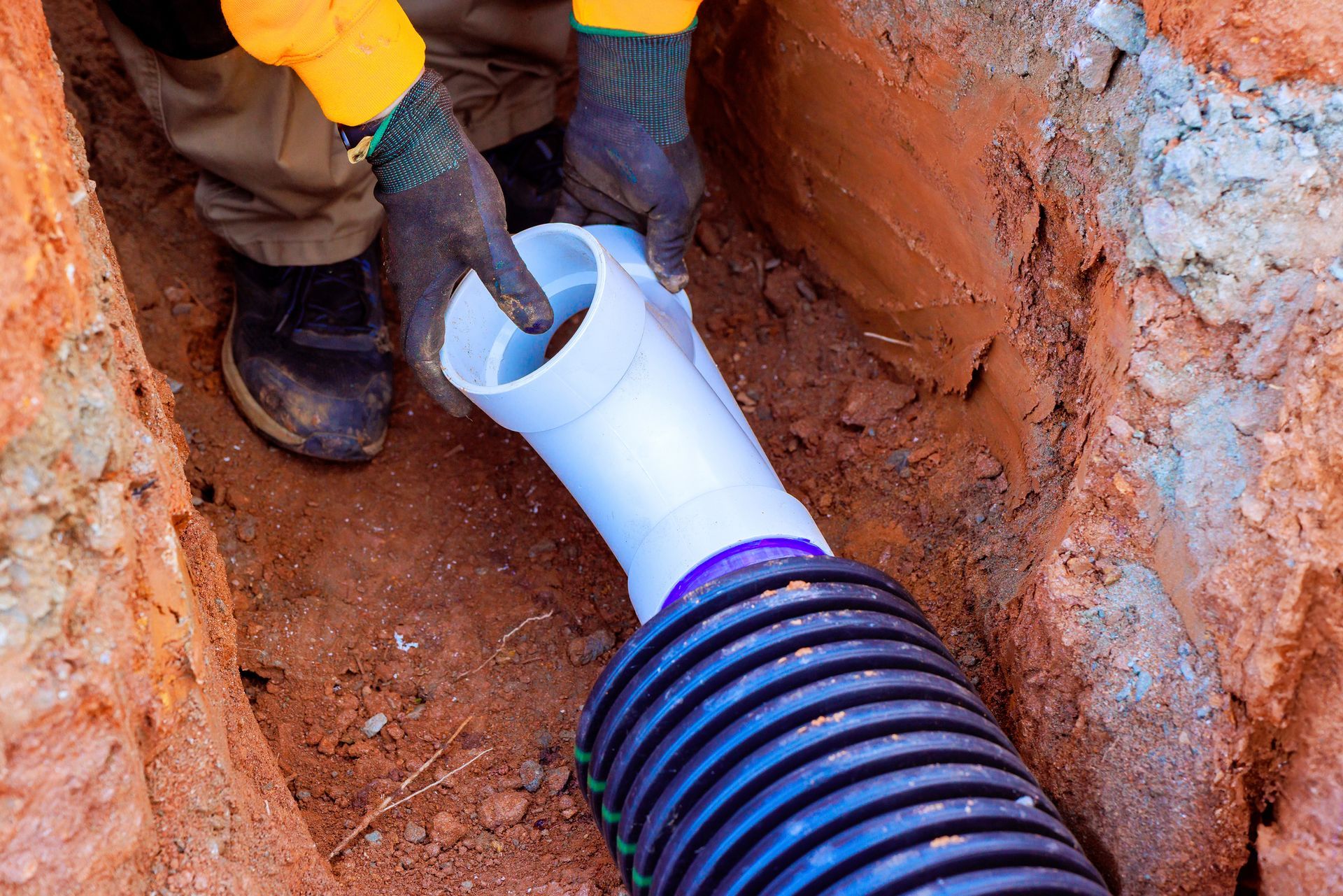 A plumbing contractor setting up a commercial drainage system. A plumbing contractor setting up a commercial drainage system.