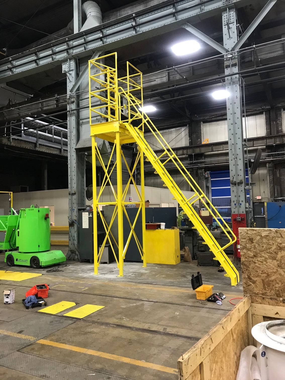 A yellow staircase is in the middle of a warehouse. A yellow staircase is in the middle of a warehouse.