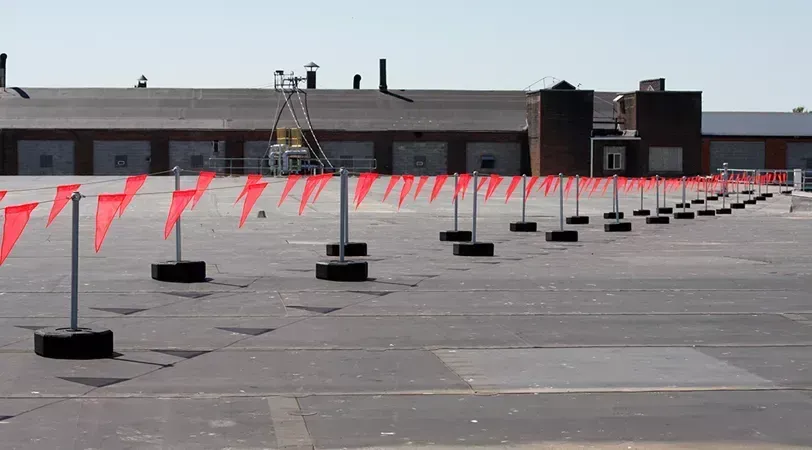 A roof with a safety line attached to it.