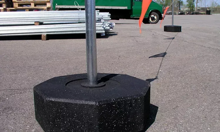 A metal pole with a rope attached to it is on a roof.
