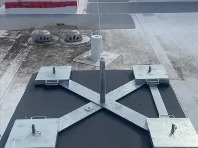 A metal structure is sitting on top of a concrete surface.