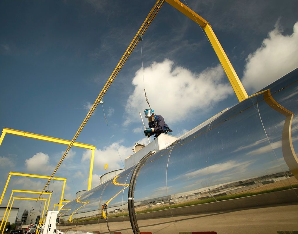 A man is working on the side of an airplane