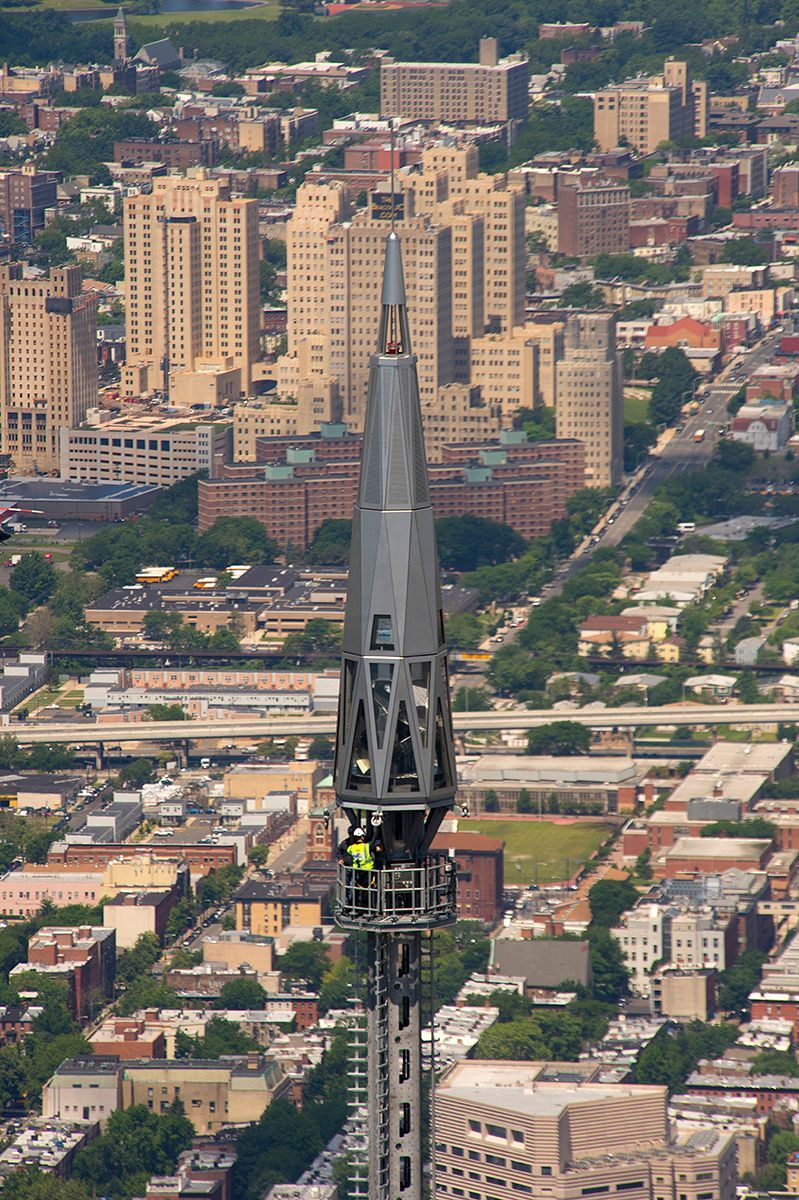 An aerial view of a city with a tower in the foreground