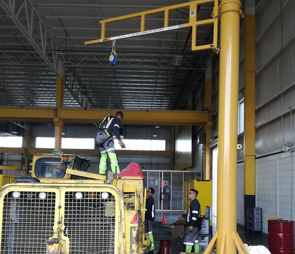 A person is attaching a rope to a metal object.