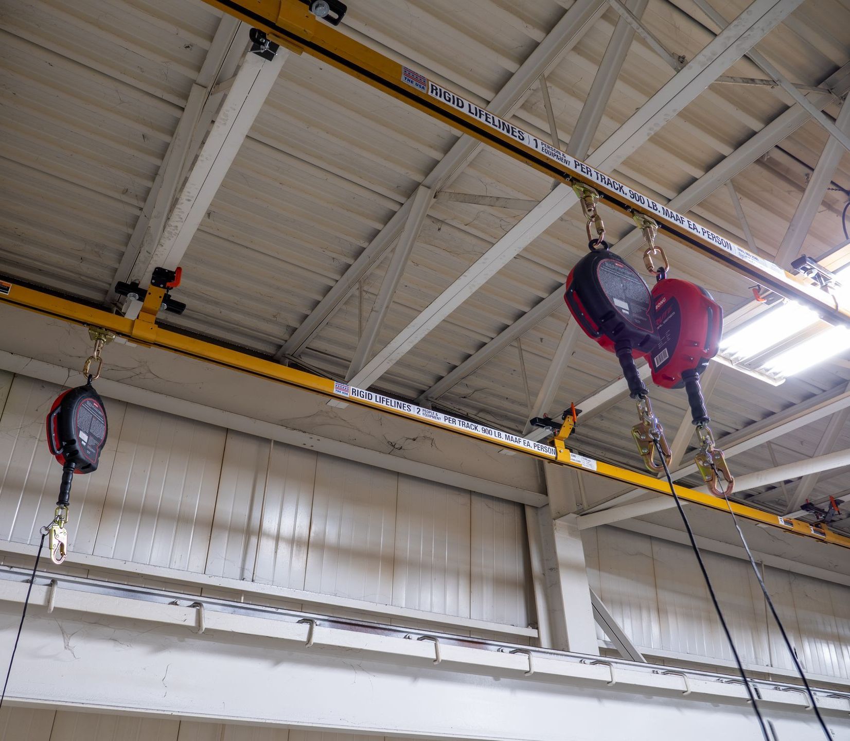 A crane is hanging from the ceiling of a building A crane is hanging from the ceiling of a building