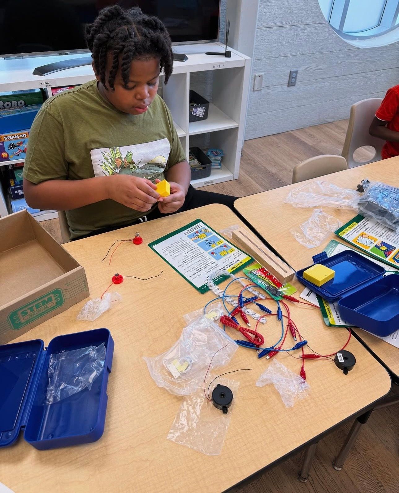 A teacher is teaching a group of children in a classroom.