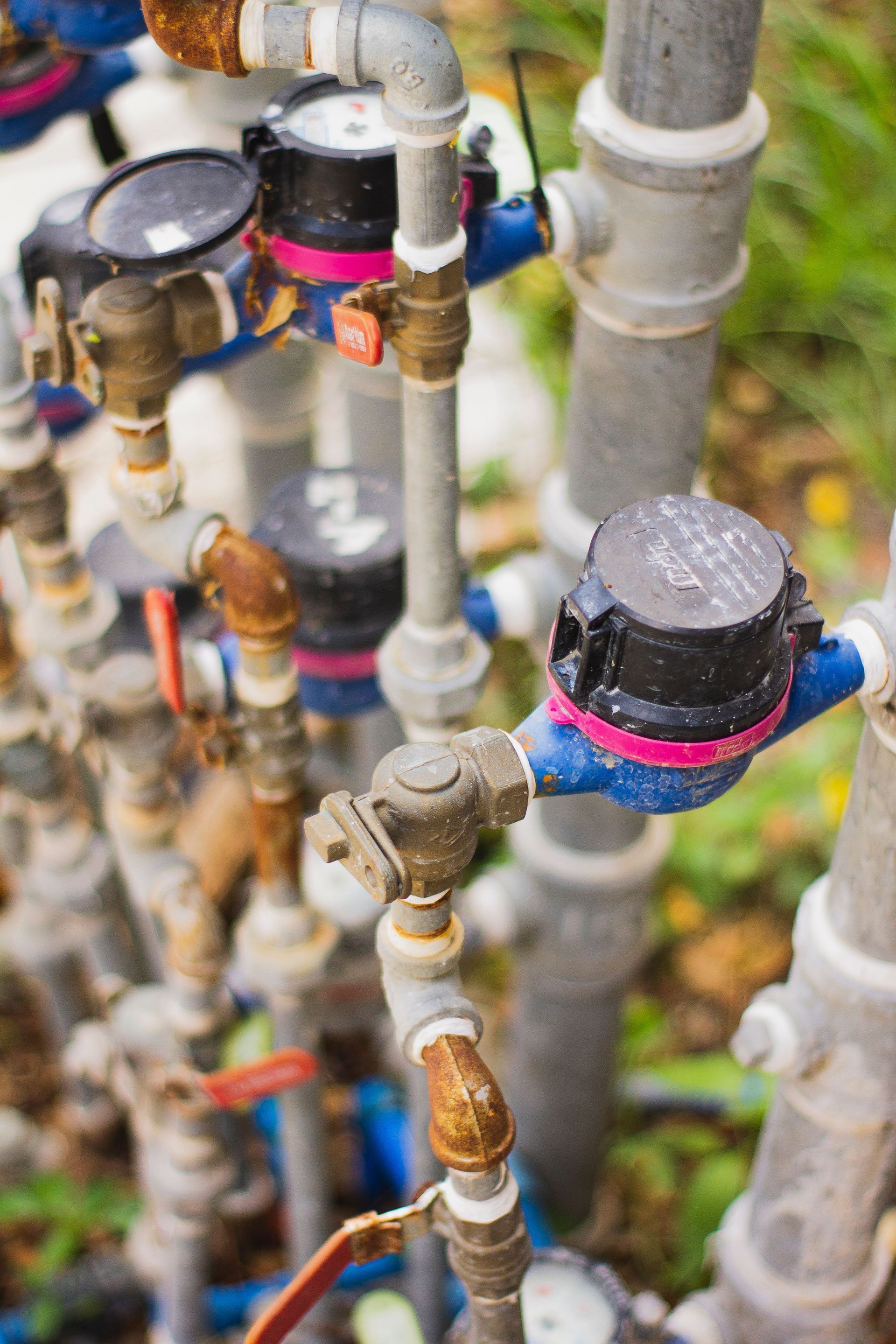 Close-up of colorful pipe fittings and valves in a dense industrial plumbing setup
