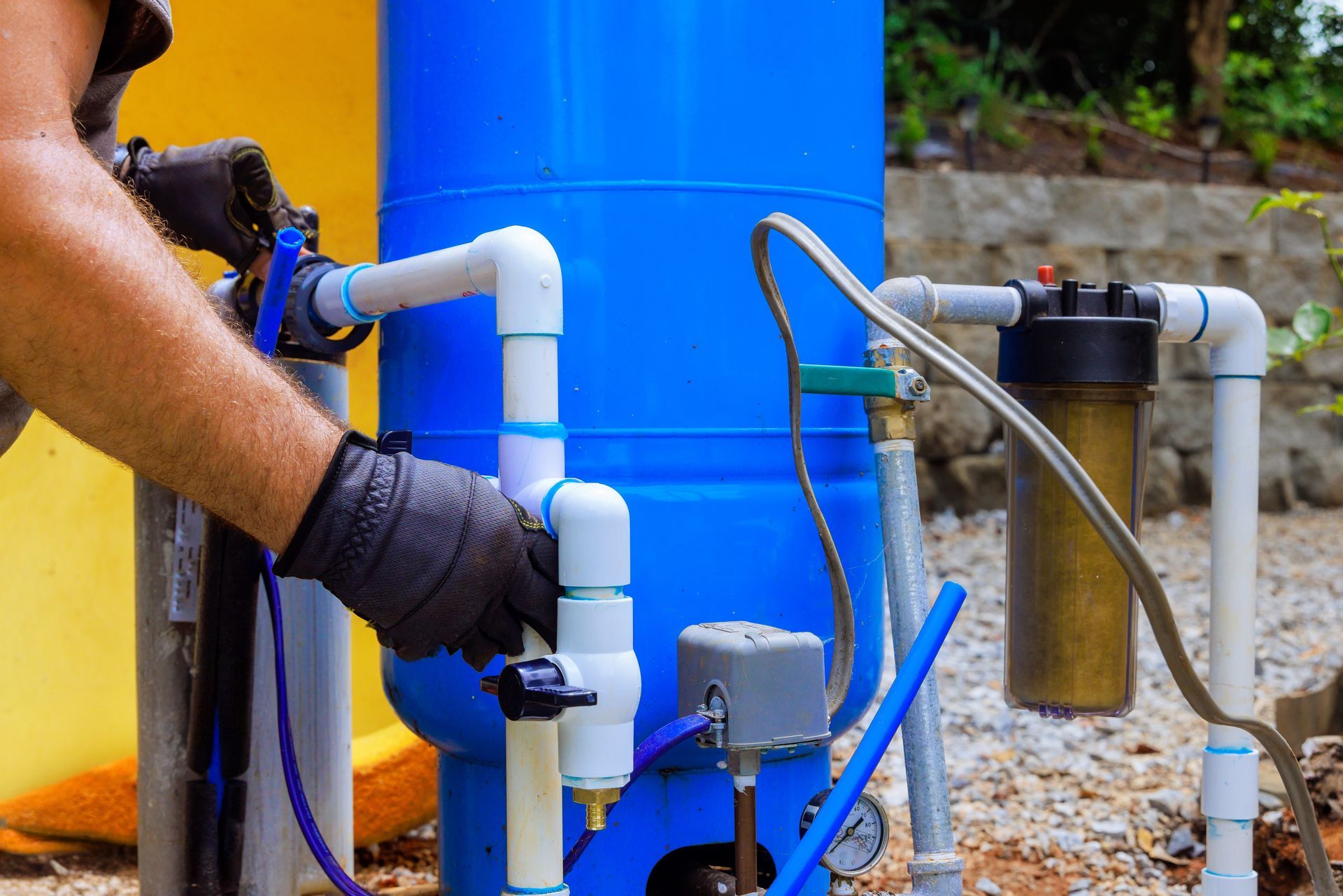 water treatment services cleveland nc Reverse osmosis water filtration system under a kitchen sink. White filters, tank, and plumbing.
