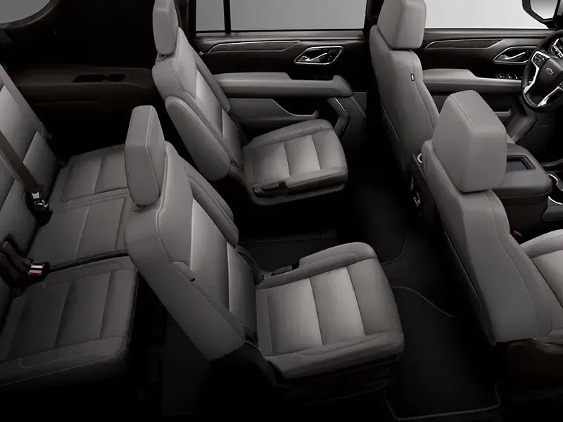 The interior of a car with a lot of seats and a steering wheel.