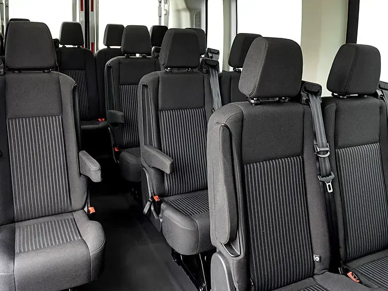 The inside of a van with a lot of seats and a window.