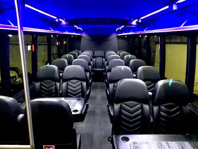 The inside of a bus with lots of seats and tables.
