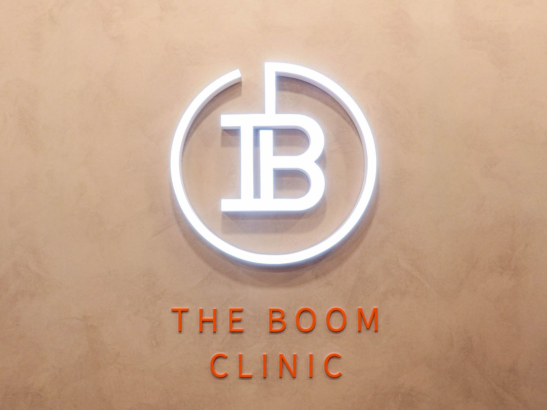 The Boom Dermatology logo and interior of the skin clinic in Busan Seomyeon