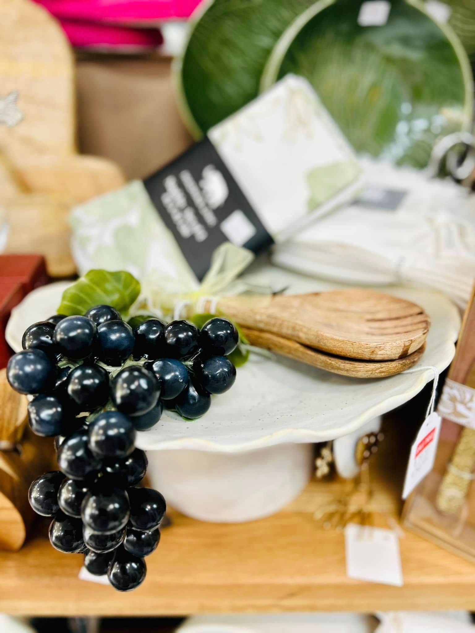 A White Scalloped Pedestal Dish is Decorated With a Bunch of Dark Blue Grapes — Kitchen Bar and More In Caloundra, QLD