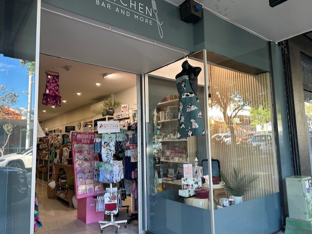 Storefront of a gift shop with colorful merchandise displayed near the entrance