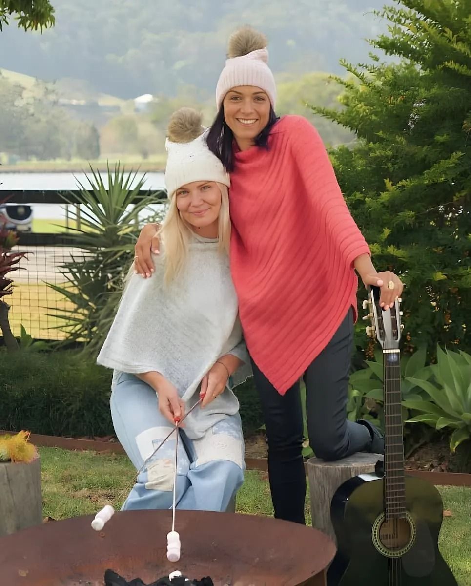 Two People in Matching Knit Hats and Ponchos Roast Marshmallows — Kitchen Bar and More In Caloundra, QLD