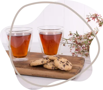 Two Glasses of Amber Tea and a Small Pile of Chocolate Chip Cookies — Kitchen Bar and More In Caloundra, QLD