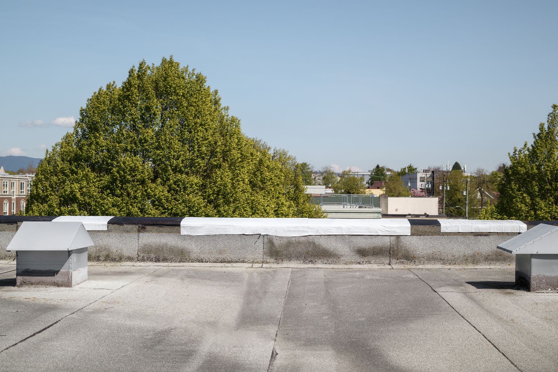 Self-adhered waterproof membrane on flat roof edge.