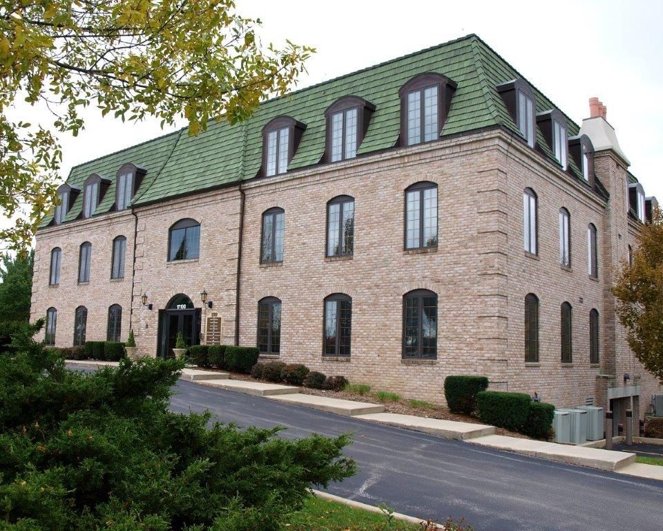 A large brick building with a green roof