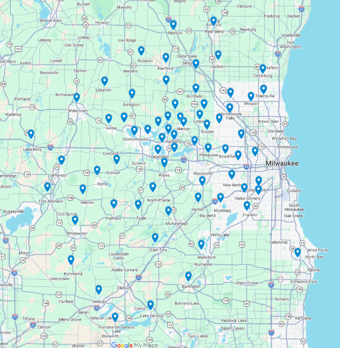 Map of Wisconsin with many blue location pins clustered around Milwaukee and scattered statewide