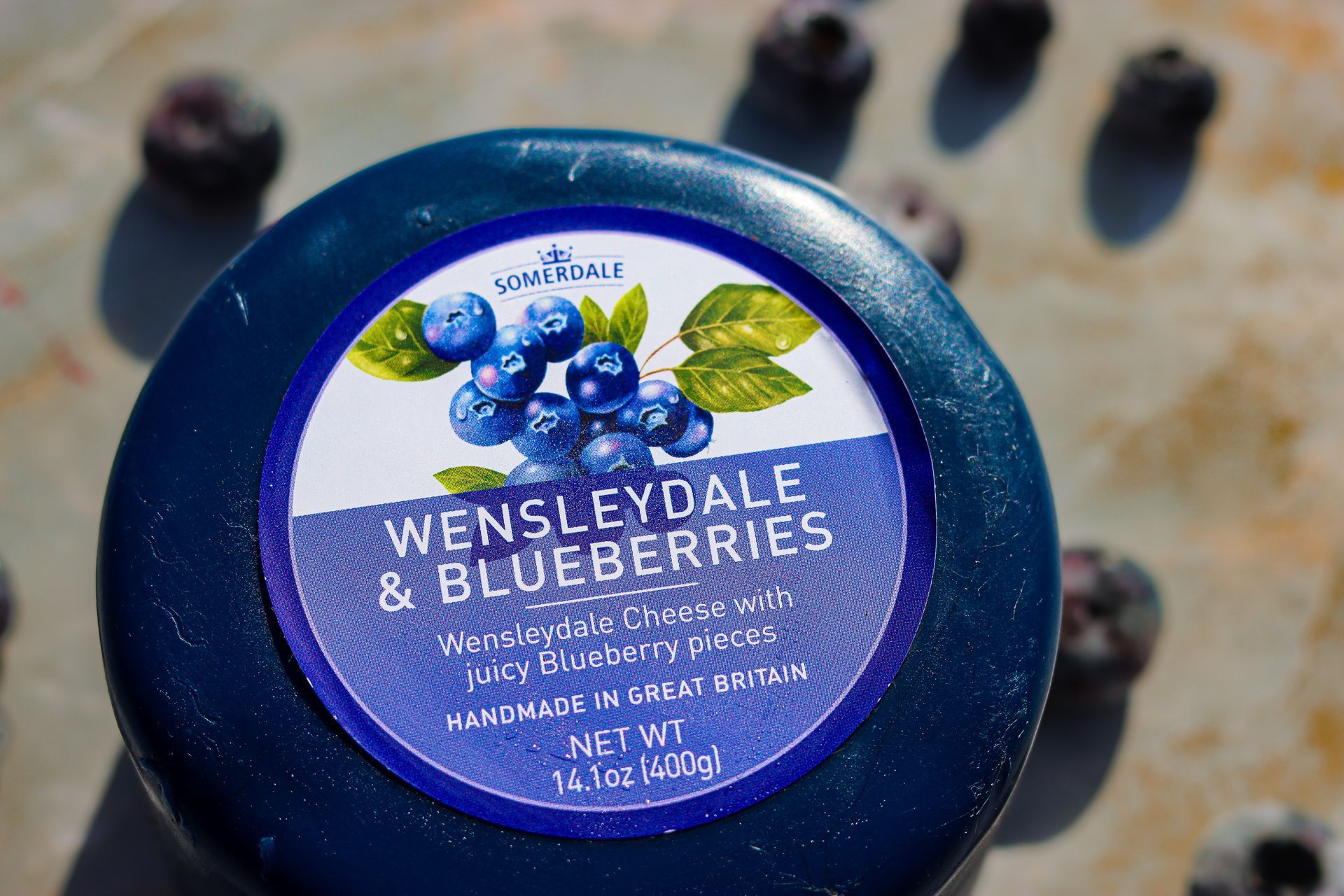 Close-up photograph of Wensleydale blueberry cheese from Great Britain, showcasing creamy white cheese with embedded blueberries and artisanal texture.