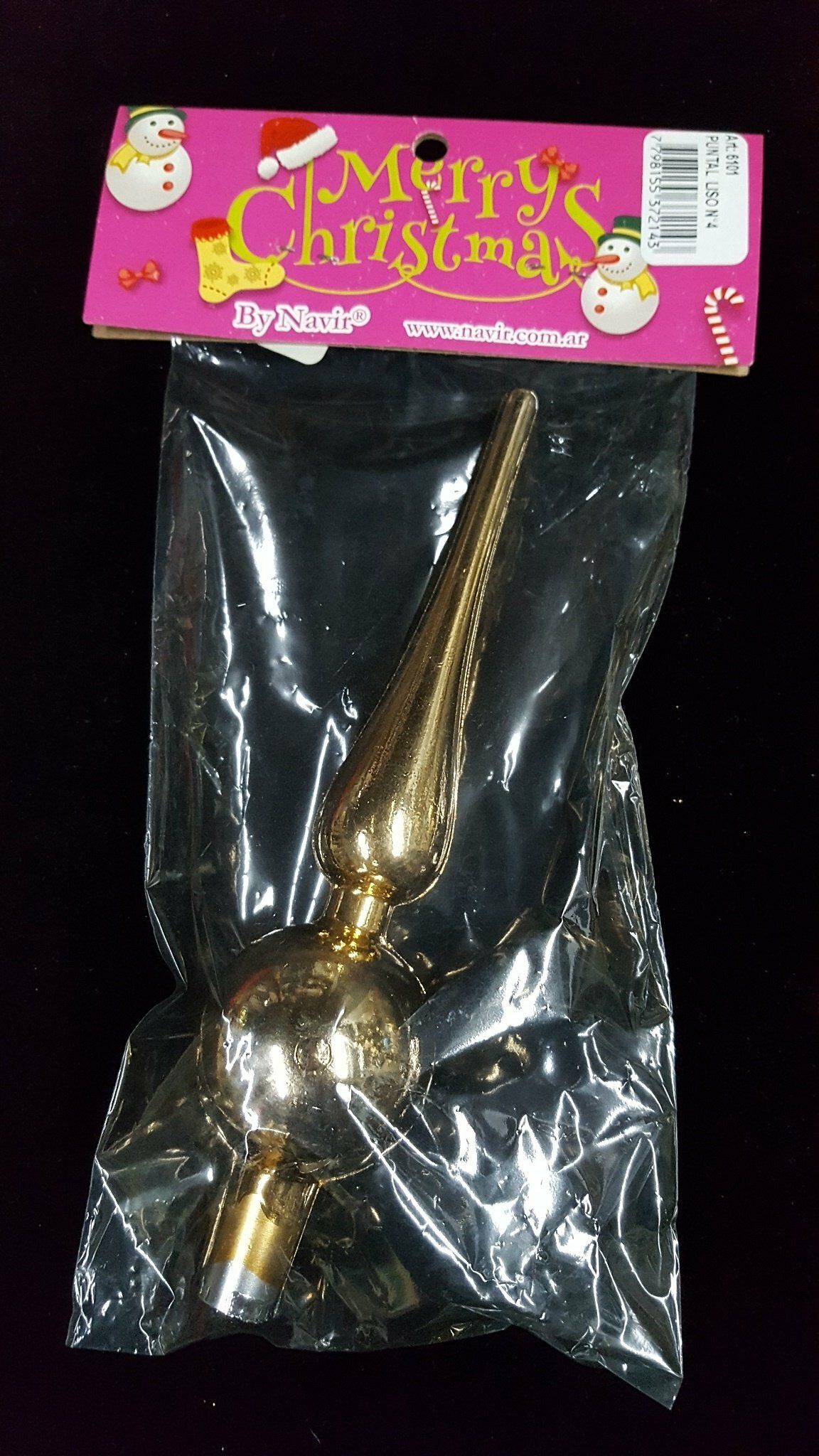 Adorno dorado para la punta del árbol de Navidad en un embalaje transparente con etiqueta navideña rosa.