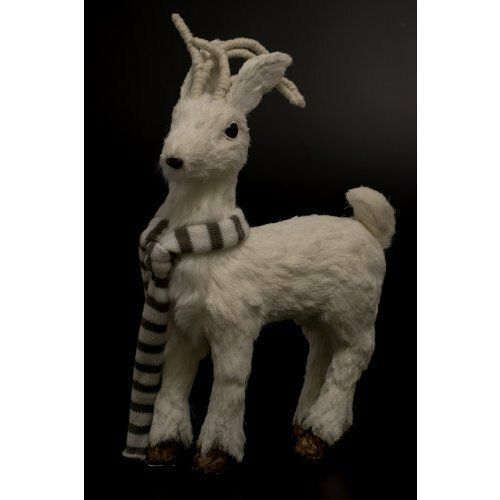 Cabra de peluche blanca con bufanda a rayas sobre fondo negro