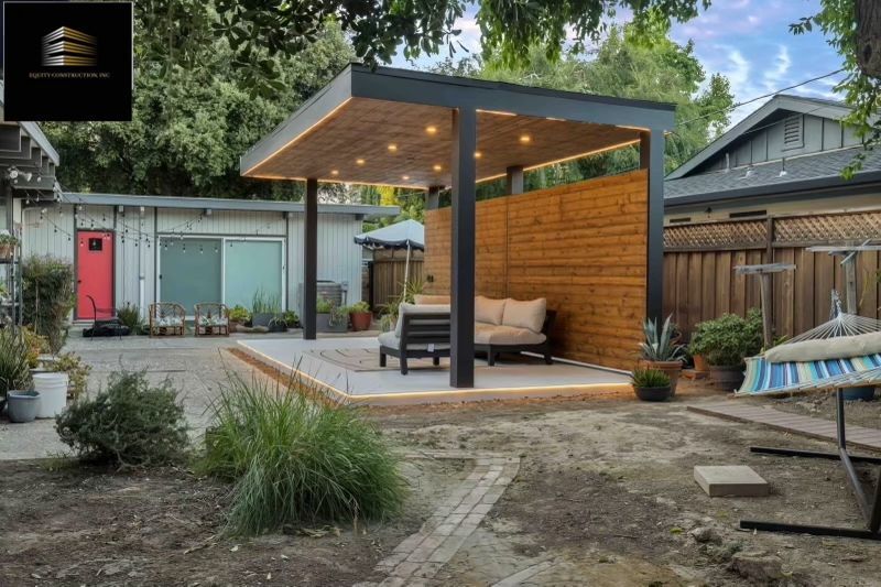 Backyard patio with wooden pergola, built-in seating, and ambient lighting.