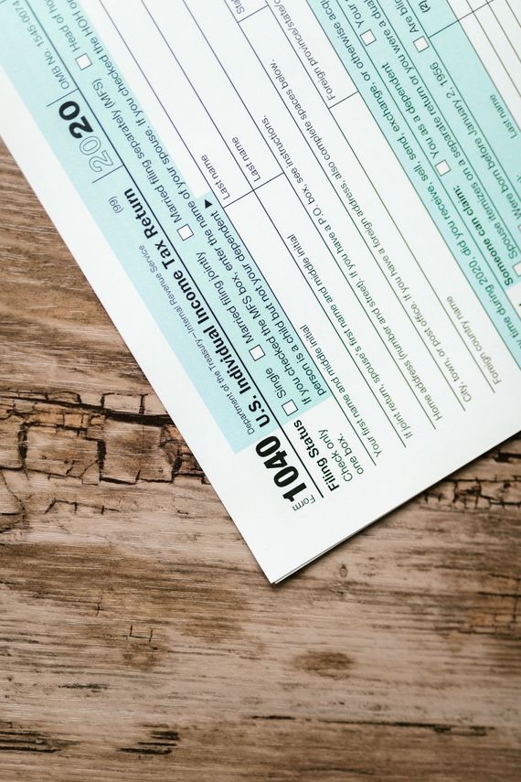 Angled close-up of a printed form with teal sections on a wooden surface